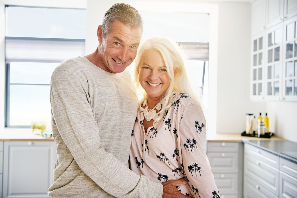 Portrait of happy couple in a bright kitchen