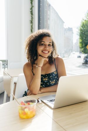 Woman using laptop in cafe