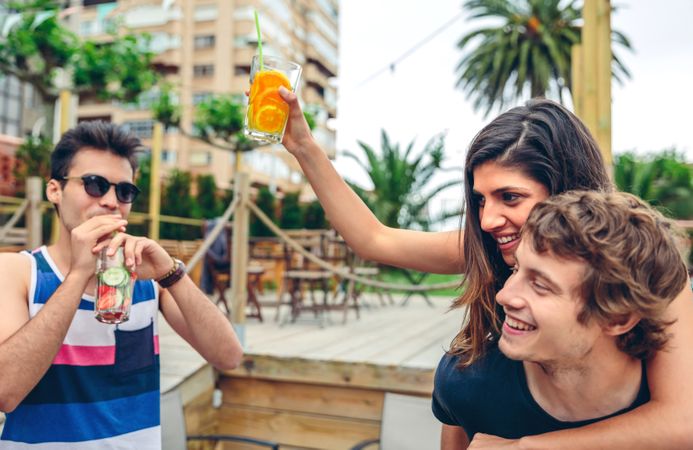 Young friends enjoying cocktails at resort