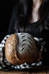 Crop person holding some bread