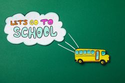 Decorative school bus and text Let's go to school on green background