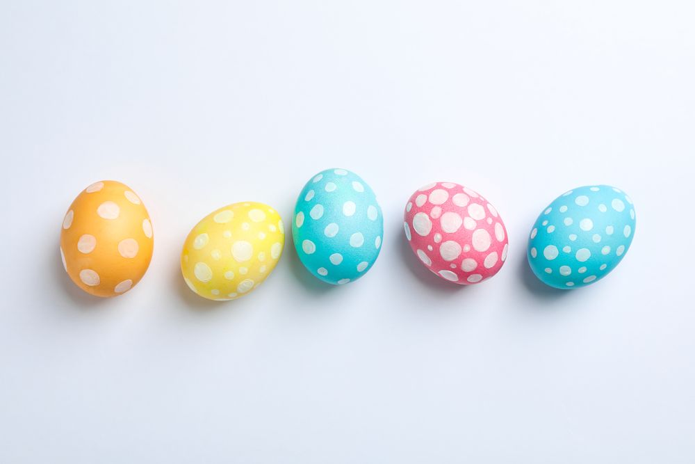 Decorative Easter eggs on plain background, space for text. Top view
