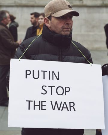 London, England, United Kingdom - March 5 2022: Man holding “Putin Stop War” sign