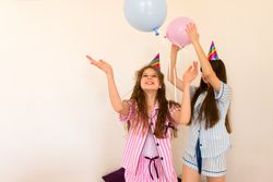 Joyful family party with balloons in cozy home setting.