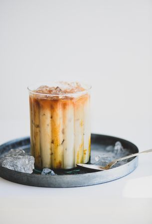 Close up of iced coffee cocktail with tray and spoon