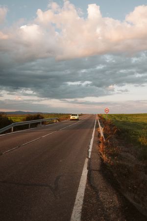 car on road along rural landscape
