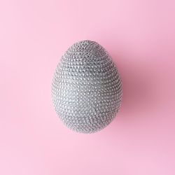 Disco ball Easter egg on pastel pink background