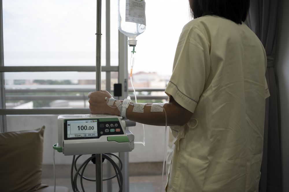 Asian female patient recovering from illness in hospital room, health care concept.