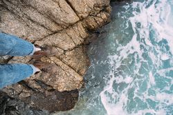 Leather boots on rocks near the coast