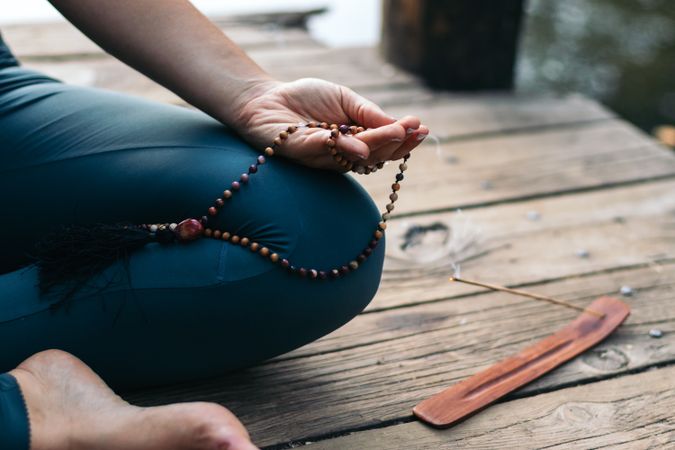 Young woman meditating and doing yoga in nature