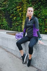 Woman in sportswear sitting outside