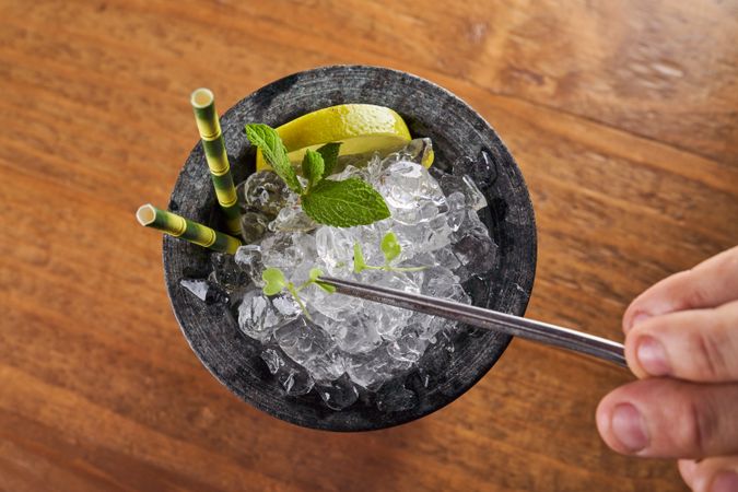 Unrecognizable person decorating refreshing drink