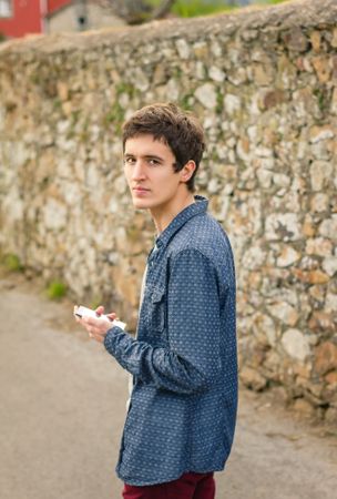 Hipster male using a smart phone outdoors