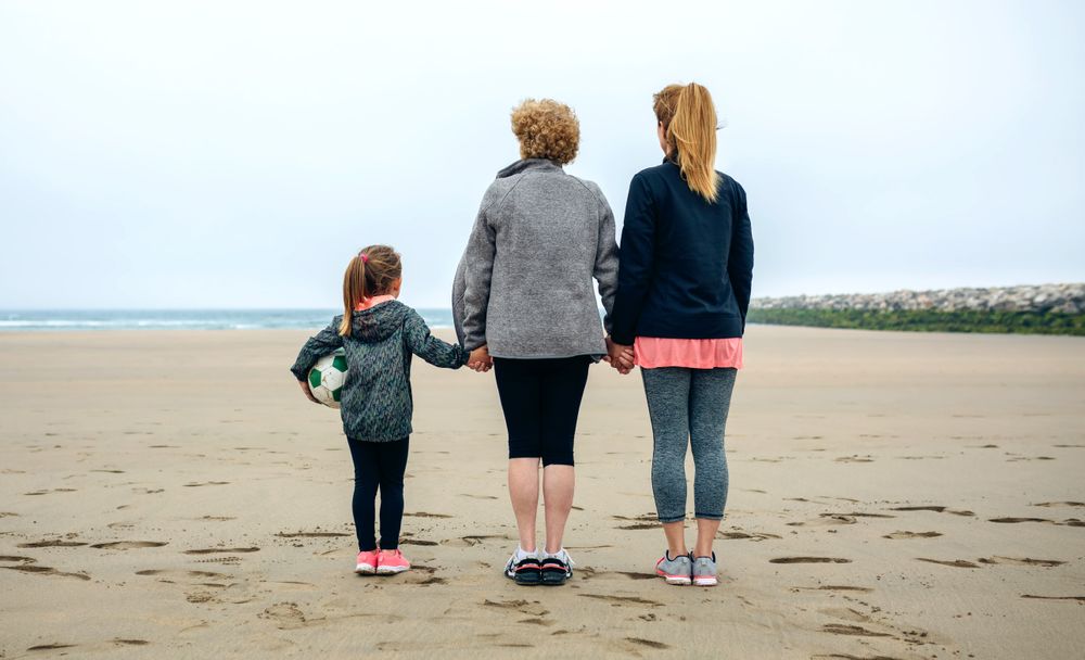 Three female generations watching the sea
