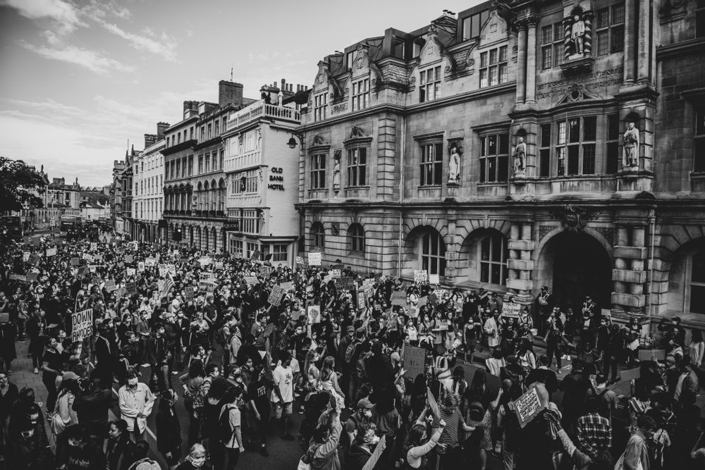 Grayscale photo of Rhodes Must Fall protest in Oxford and the Black Lives Matter March