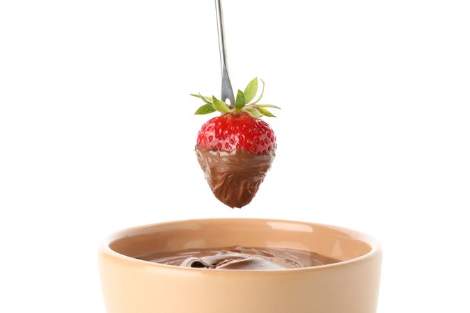 Chocolate fondue. Strawberry in chocolate isolated on blank background