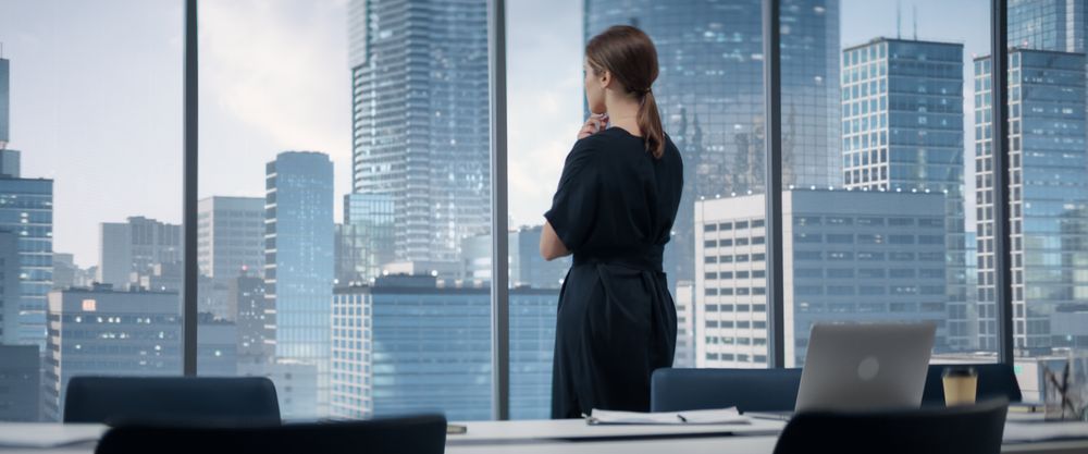 Businesswoman Entering Her Corner Office With Big City View.