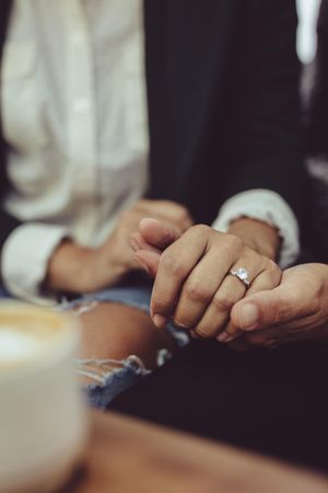 Loving couple holding hands at coffee shop together
