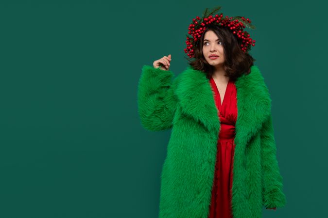 Woman in green faux fur coat and red dress