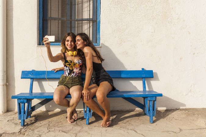 Girlfriends sitting on bench