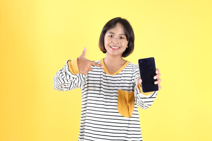 Smiling Asian Kids Pointing on Mobile Phone Screen