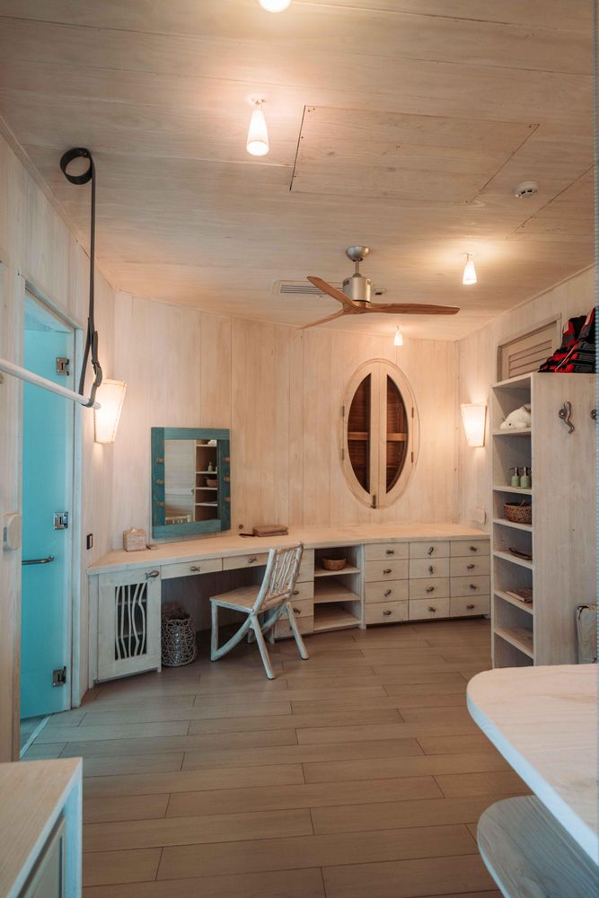 Interior view of room with dresser table and wooden shelves