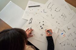 Designer creating draft of handmade accessories