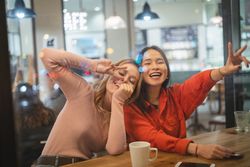 Multiethnic friends talking in cafe
