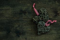 Valentine's day concept of thatched heart shaped decorations on wooden table