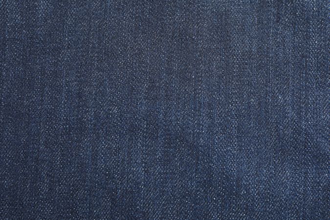 Texture of blue jeans as background, space for text