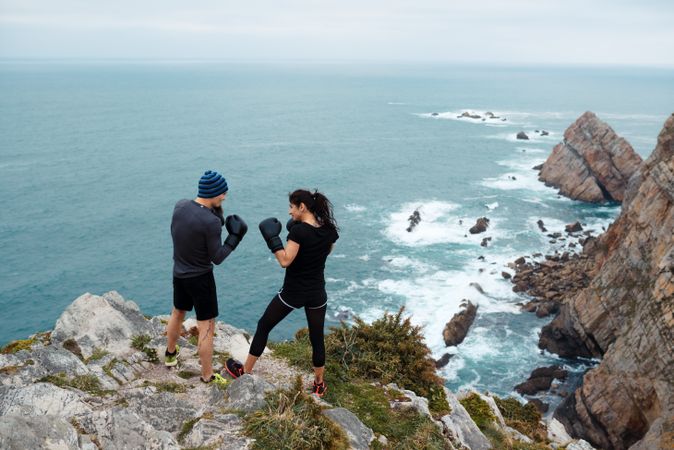 Boxers exercising on cliff