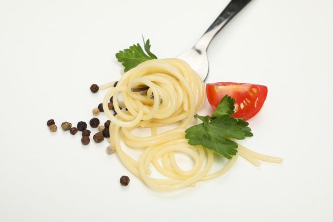 Fork with tasty pasta isolated on blank background