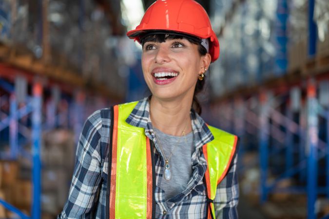 Smiling woman in hard hat and high visibility jacket