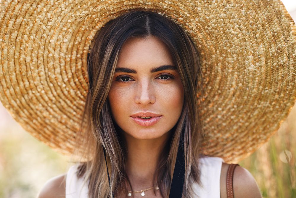 Portrait of beautiful woman in straw hat