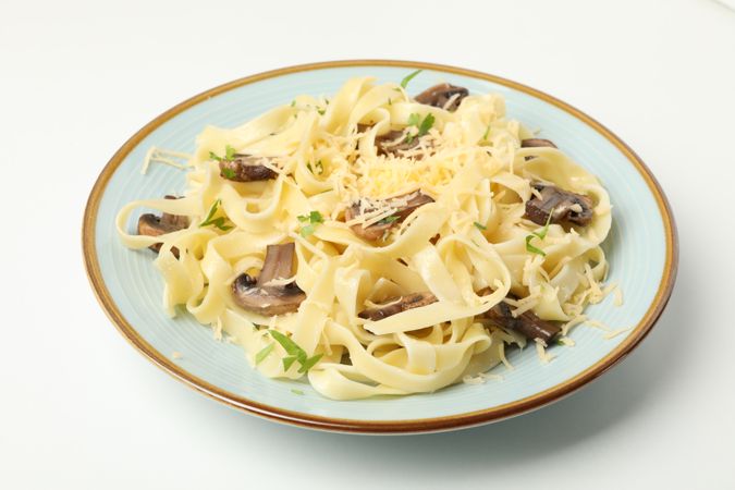 Plate with pasta, cheese and mushrooms isolated on blank background