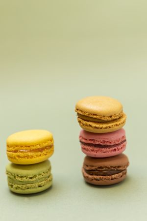 Two piles of colorful macaroons on a marble background