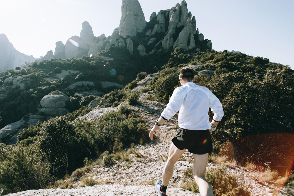 Man training on rocky trail in the hills