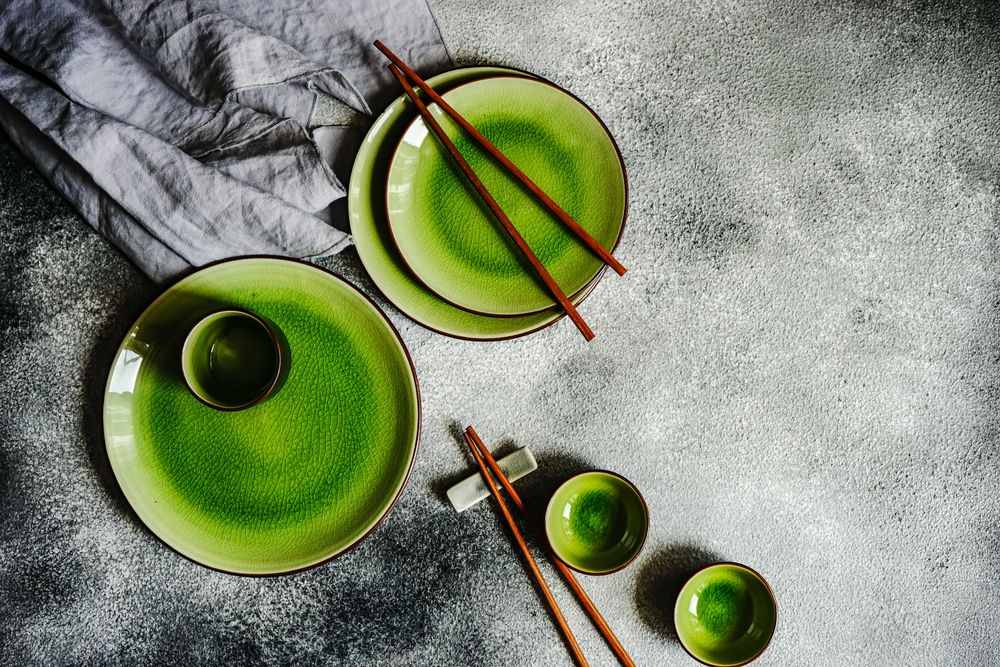 Green table setting with chopsticks and cups