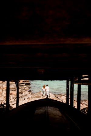 Amorous couple hugging on coastal pier