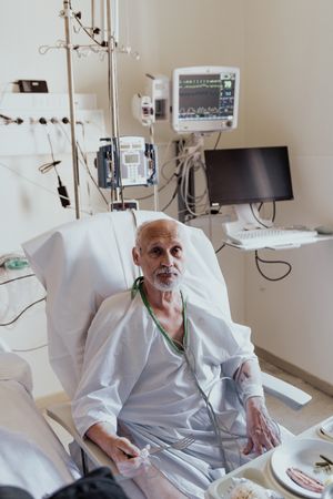 Older man admitted to a hospital room.