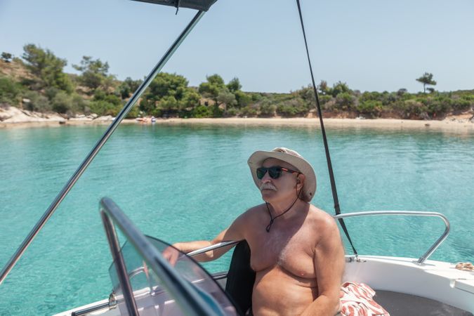 Man sailing in boat in clear turquoise water