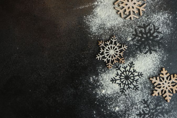 Top view of flour scattered on snowflake shapes