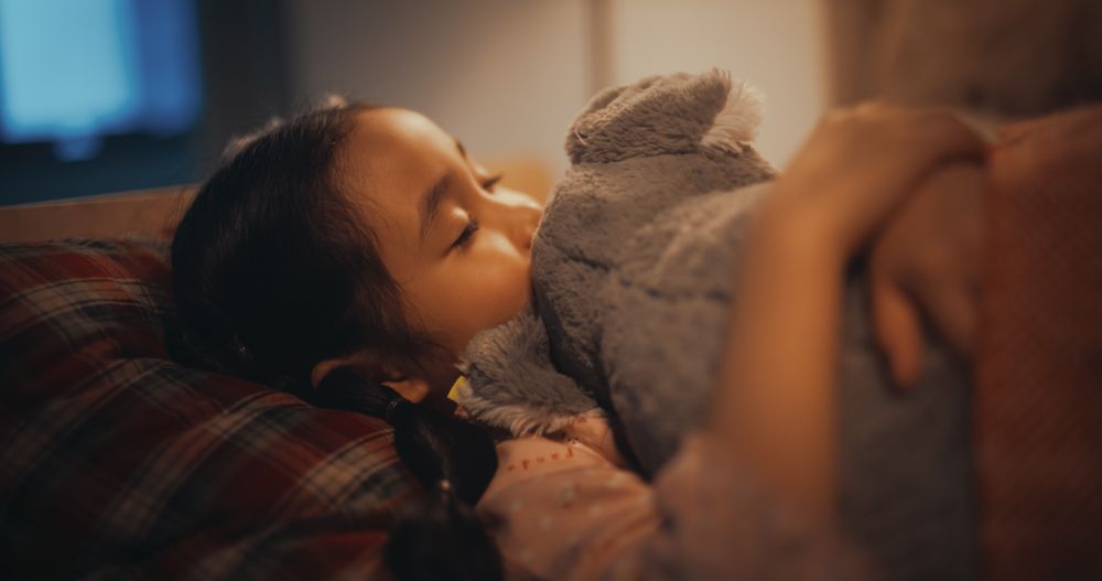 Cute Female Child Having Good Dreams, Feeling Safe at Home with Soft Warm Light On