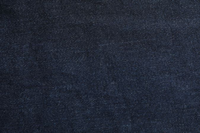 Texture of blue jeans as background, space for text