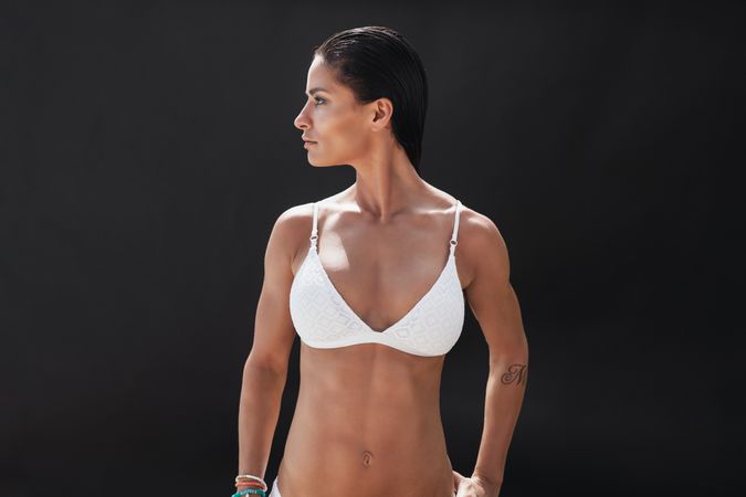 Muscular young woman in swimwear