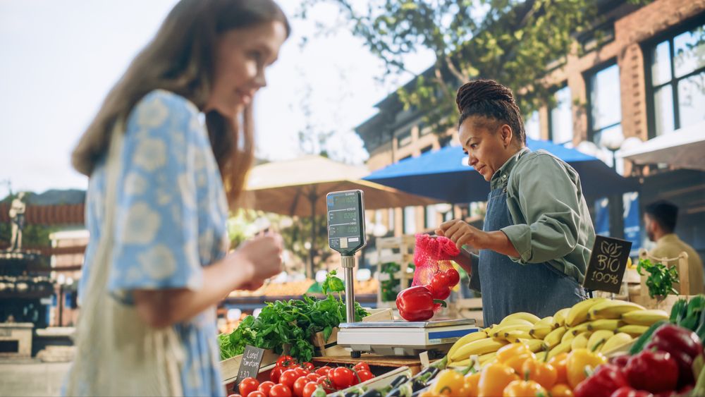 Black Female Running a Small Business on a Farmers Market, Selling Organic Fruits and Vegetables.