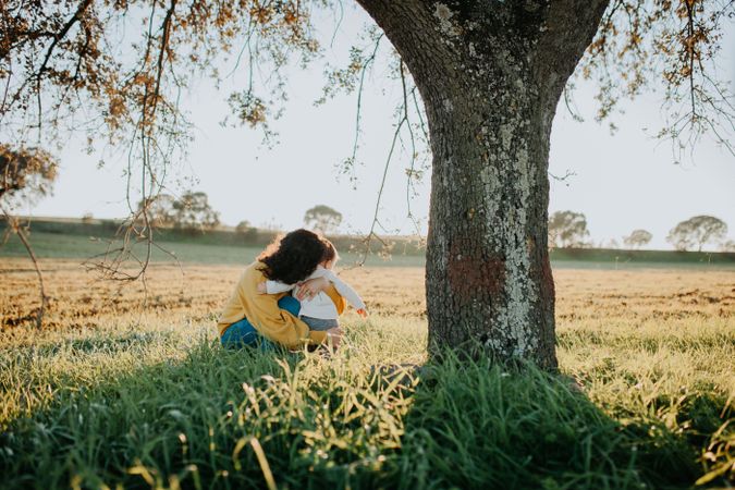 Mother hugging her child in a field