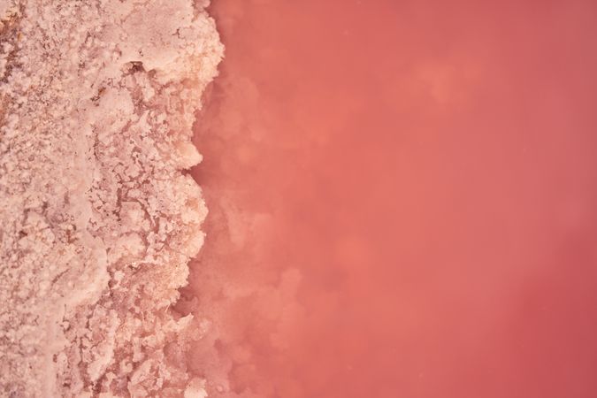 Salty pink water on seashore