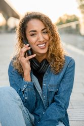 Smiling woman talking on smartphone