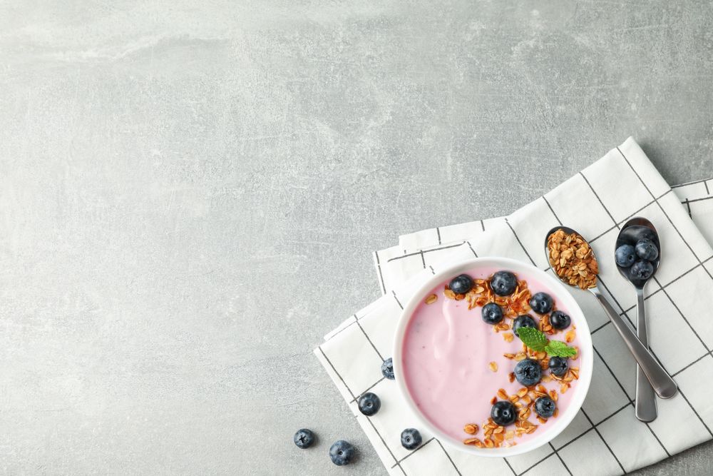 Composition with tasty yogurt on grey background, space for text